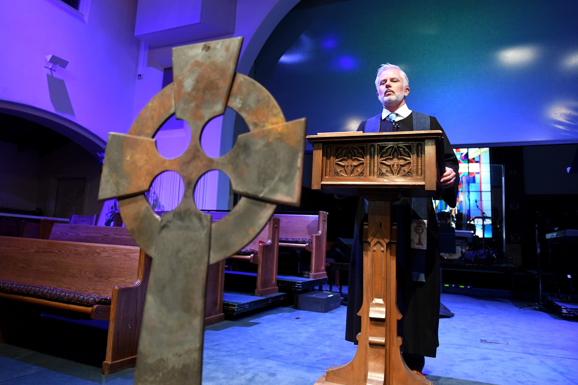 The Rev. Matt Hardin, leads an evening prayer service at Brentwood Presbyterian Church, which has housed his congregation since the Palisades Fire destroyed his church one year ago, on Tuesday January 6, 2026. The cross in front of his pulpit is the only thing from Palisades Presbyterian Church that survived the fire. (Photo by Axel Koester, Contributing Photographer)
